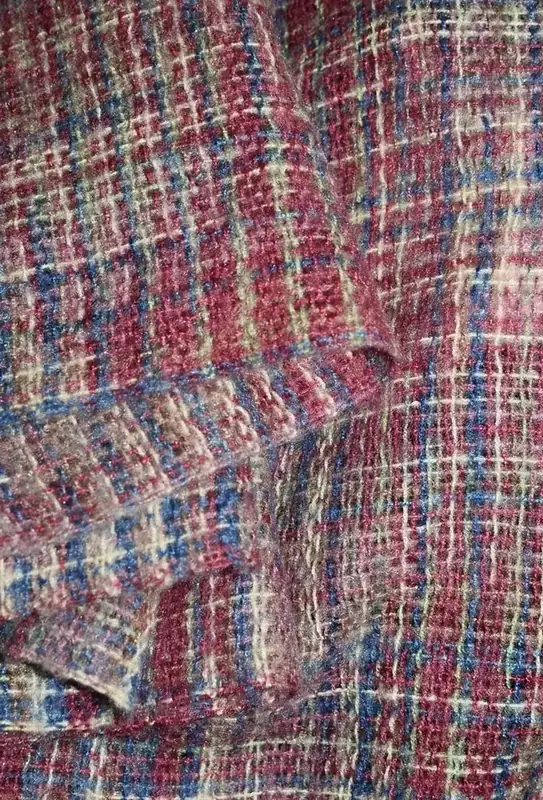 Close-up of woven pink, blue and cream tweed fabric